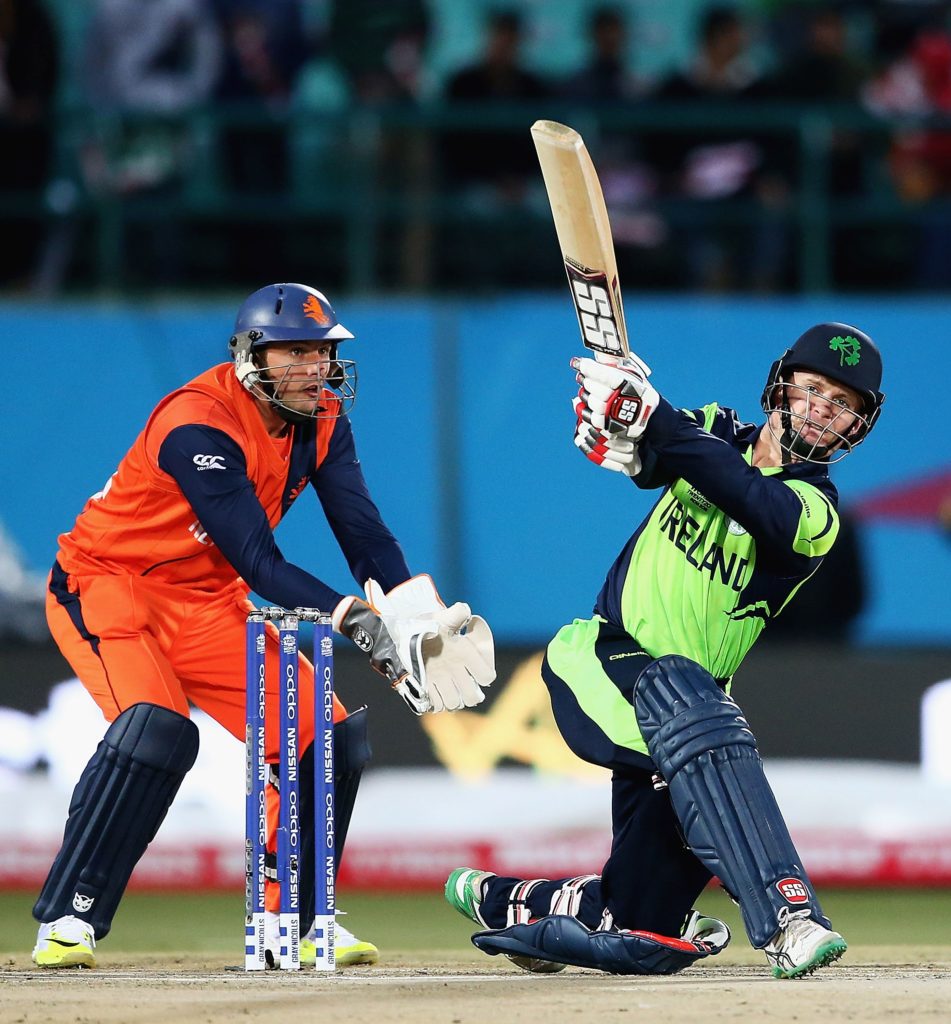 William Porterfield, Captain of Ireland hits the ball towards the boundary, as Wesley Barresi of the Netherlands looks on during the ICC World Twenty20 India 2016 match between Netherlands and Ireland at the HPCA Stadium on March 13, 2016 in Dharamsala, India.